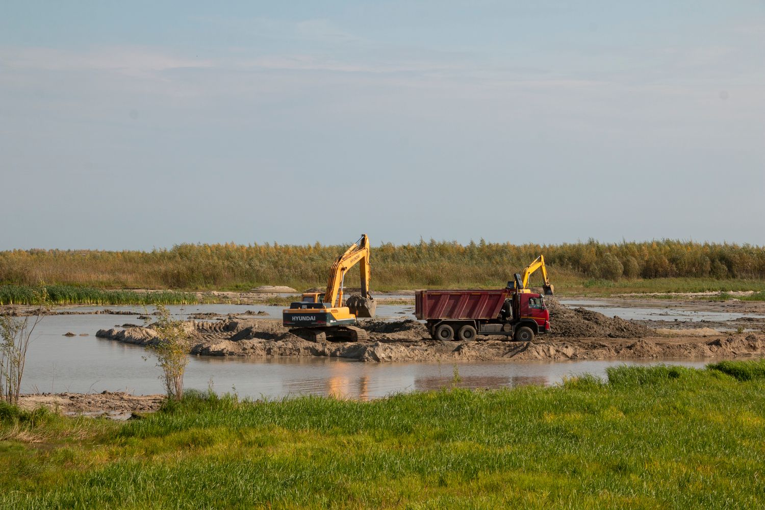 Excavator working beside a pond in Tennessee